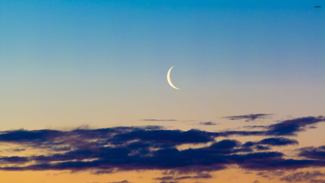 Featured image of a waning moon over a calm landscape